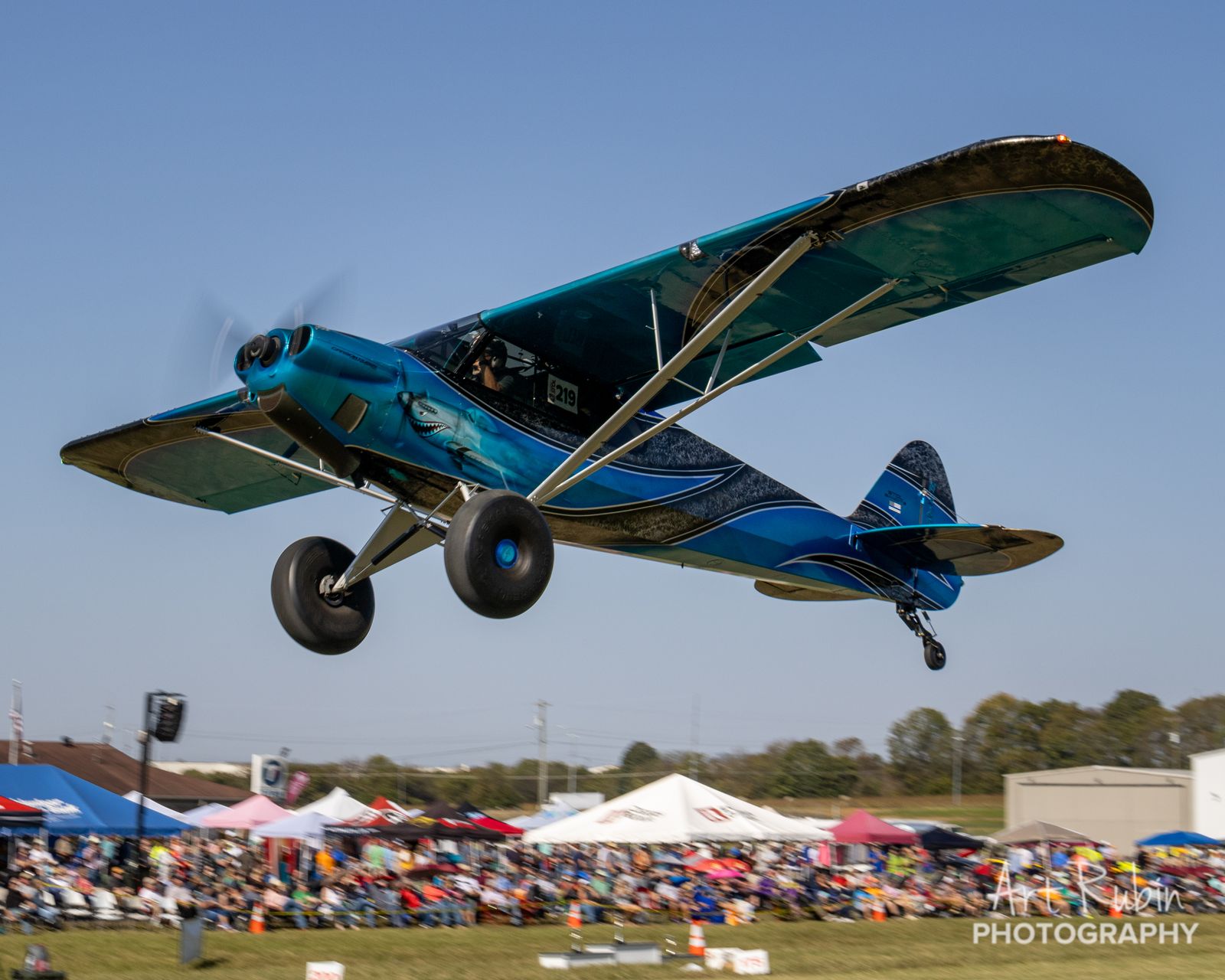Shark-livery Cub on a low pass over the crowd tents