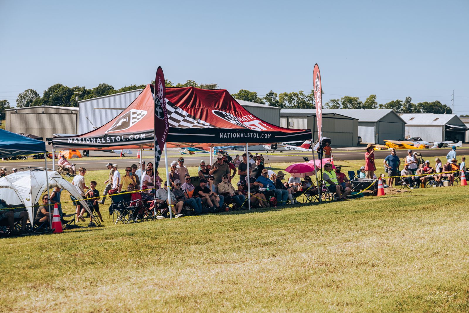 Spectators packed under the sponsor tents on the flight line