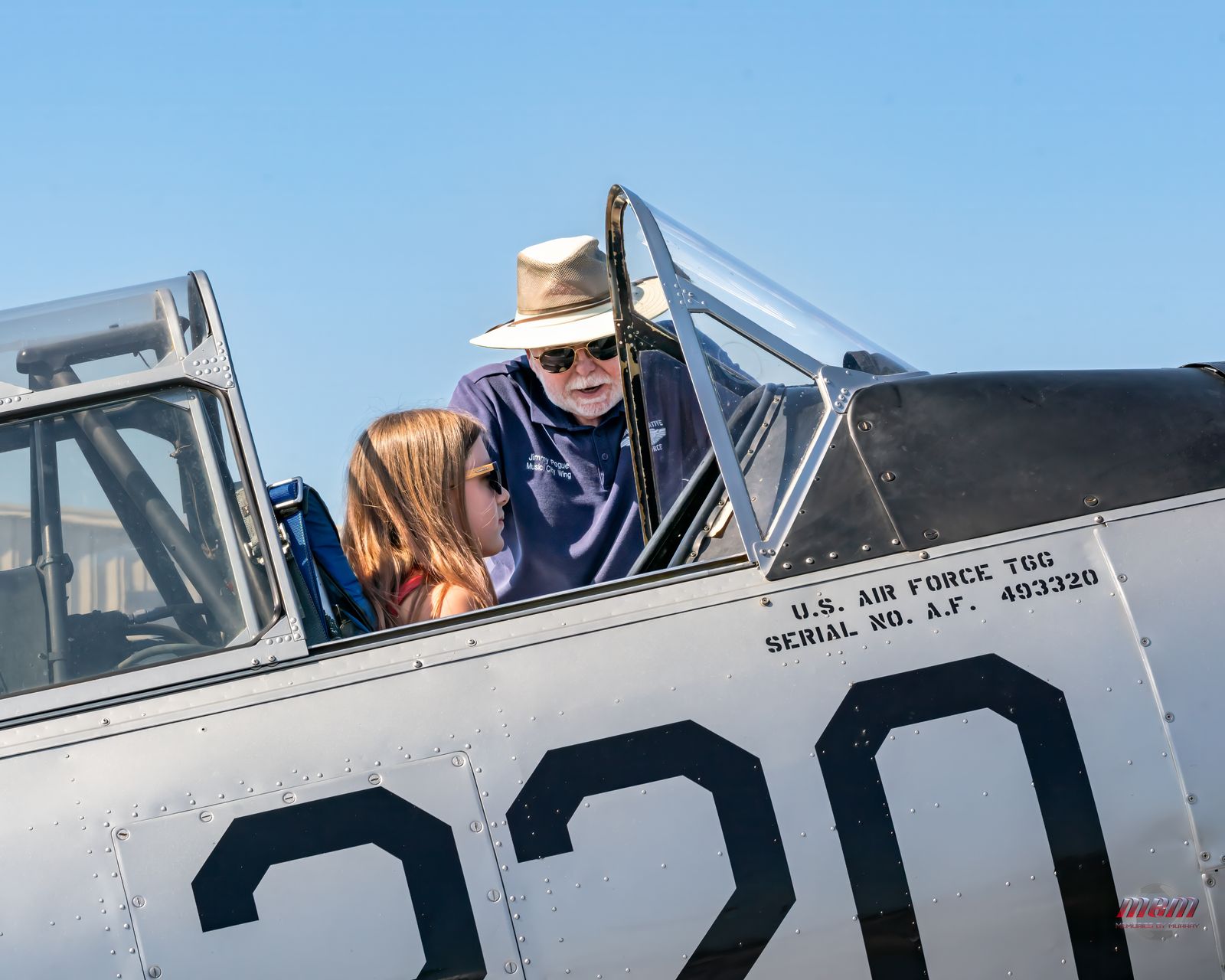 A young fan gets a look inside a warbird cockpit