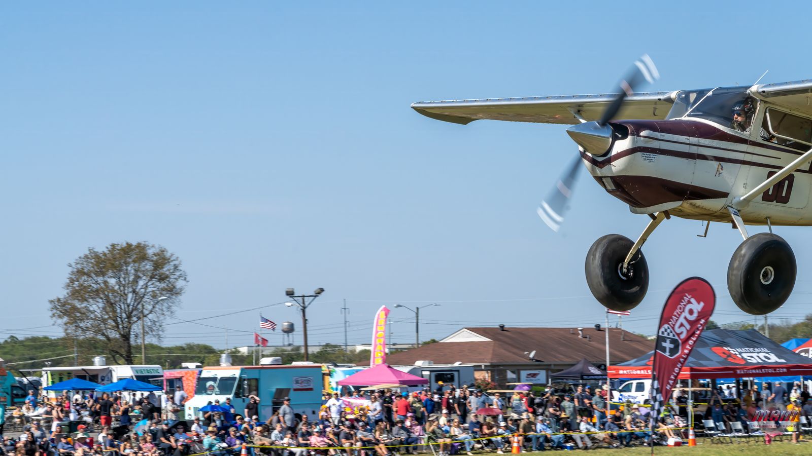 Competitor touching down with food trucks and crowd behind