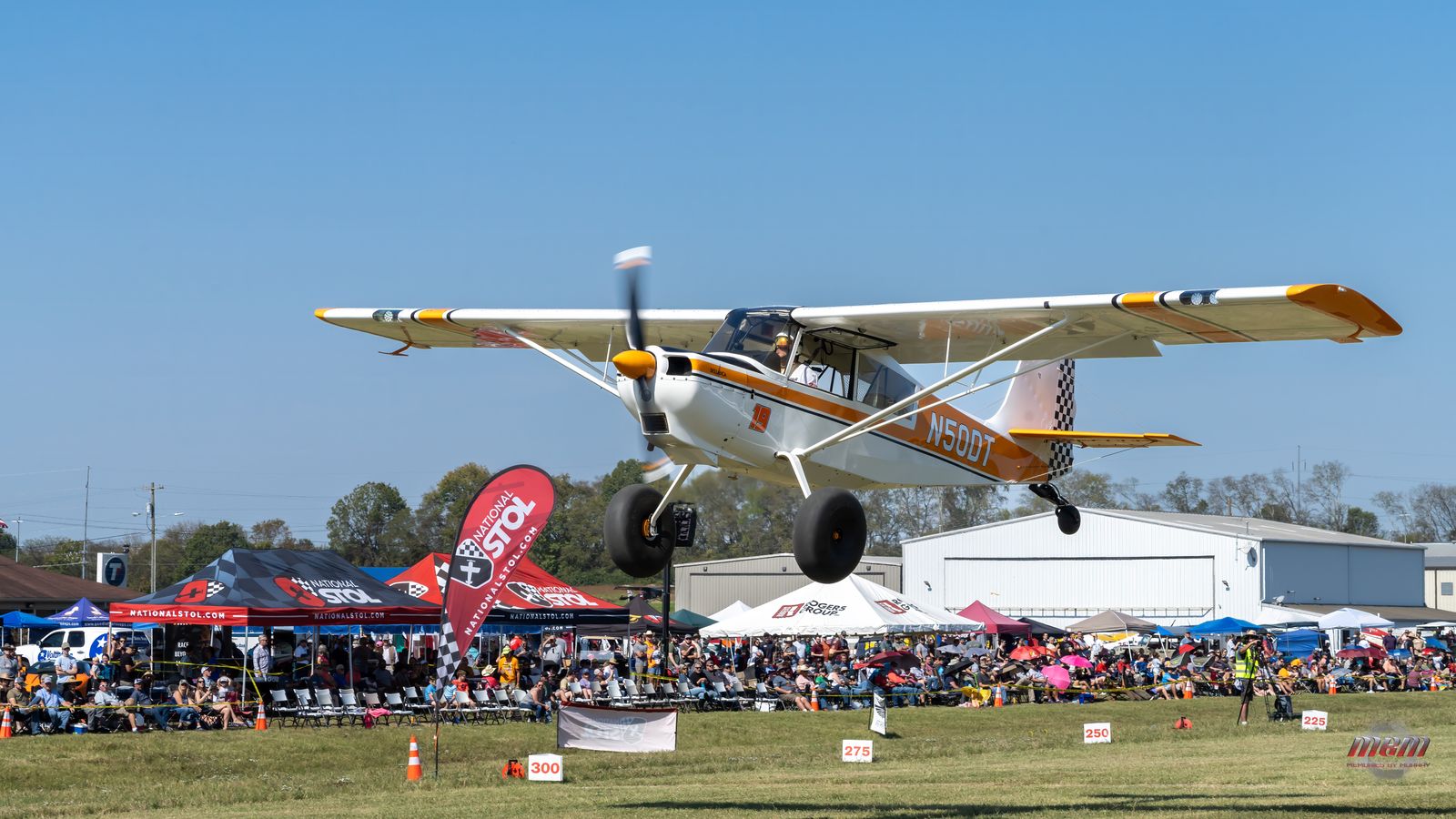 Liftoff over the packed spectator and vendor row