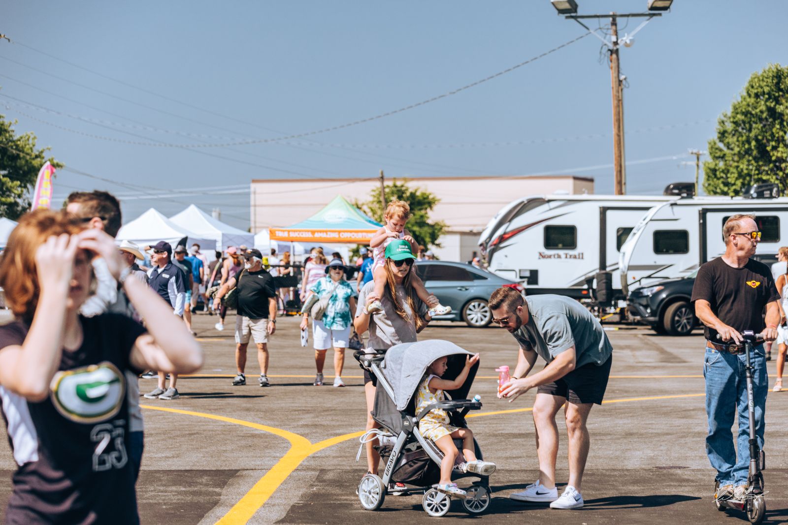 Families and kids exploring the campground midway