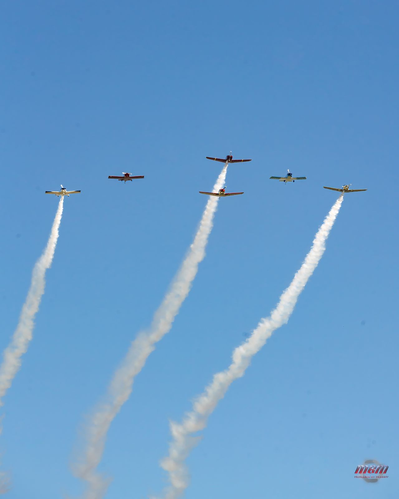 Five-ship formation flyover trailing smoke