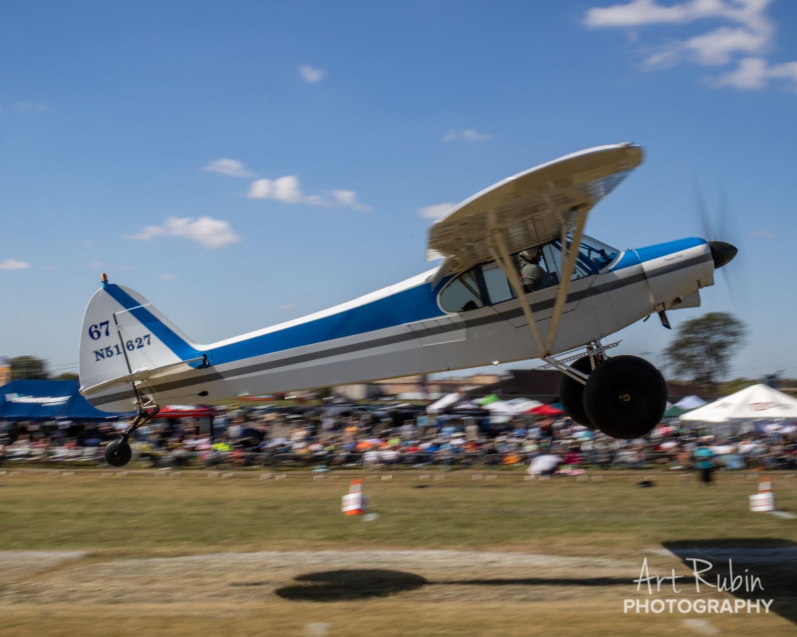 Competitor airborne over a massive spectator crowd