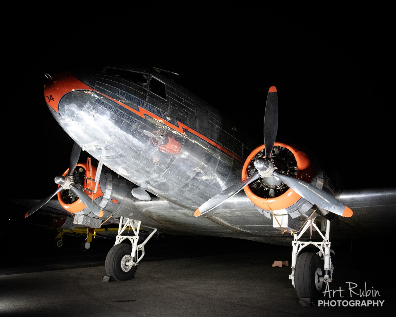 Vintage DC-3 dramatically lit against the night sky