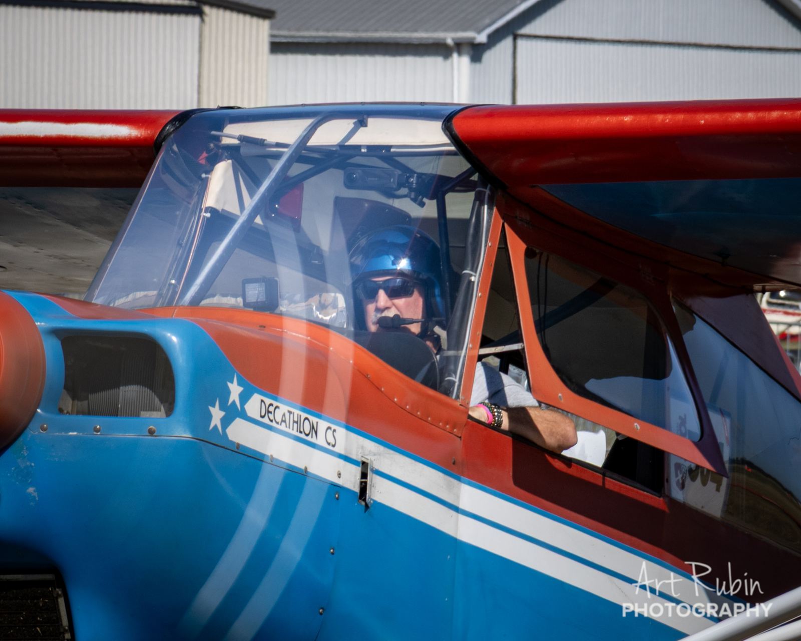 Pilot ready on the line in a red, white and blue taildragger
