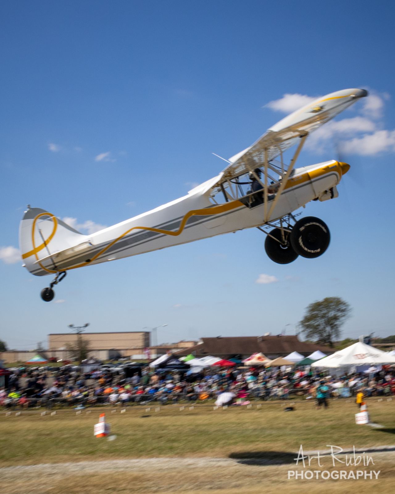 STOL aircraft climbing out over the spectator crowd