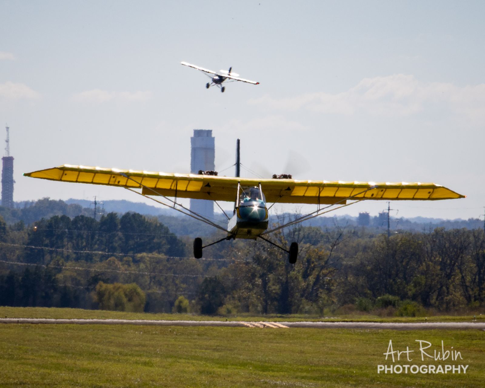 Two aircraft working the pattern over the field