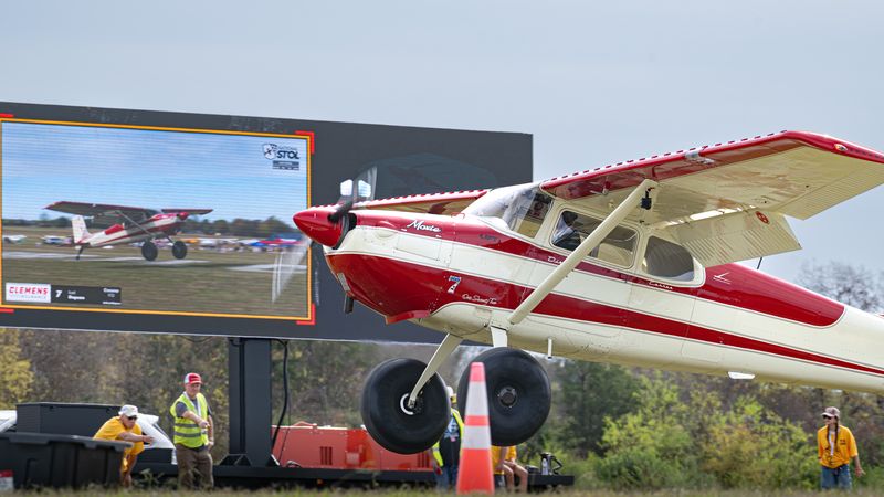 Race 68 · Nick Ardillo · CubCrafters Carbon Cub on short final past the line judges, LED wall behind