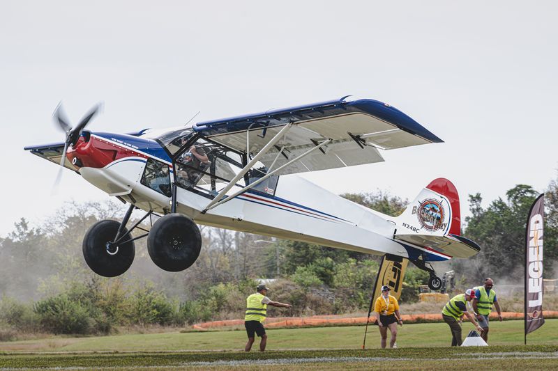 Race 30 · Brandon Corn · Backcountry Super Cub N24BC flaring over the line as the judges watch