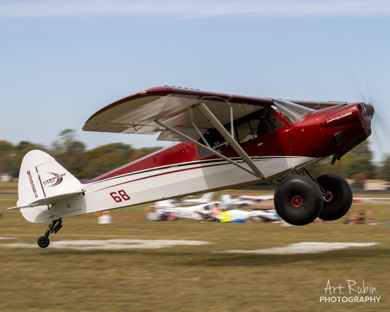 Race 68 · Nick Ardillo · CubCrafters Carbon Cub airborne over the crowd