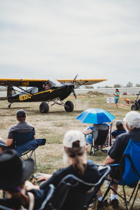 Race 333 · Dan Watson · Piper PA-18 N333S taxis past fans under umbrellas